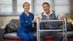 Smiling home health nurse assisting a happy elderly man seated with a walker